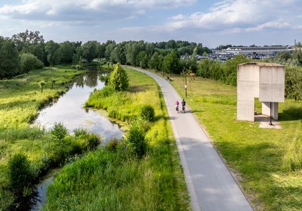 Luftaufnahme von zwei Radfahrern auf einem Radweg entlang der Ems im Flora-Westfalica-Park